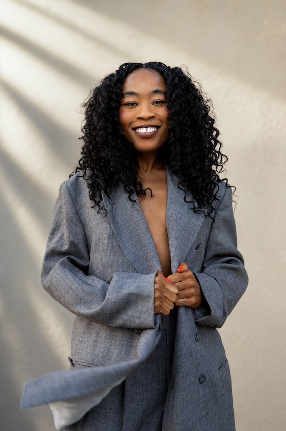 Nana Ghana smiling in a gray blazer